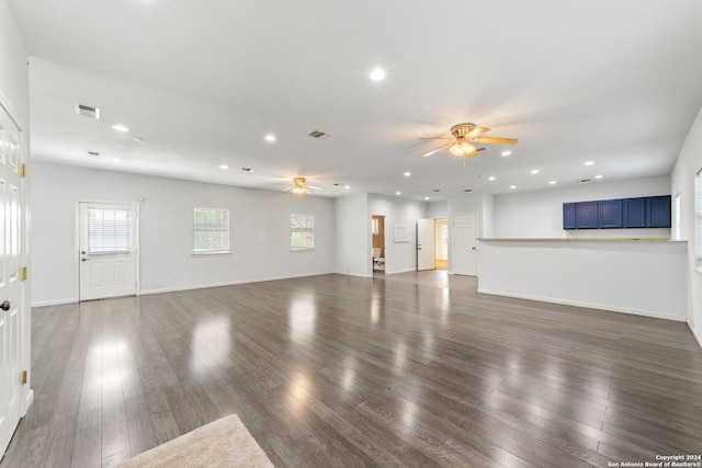 unfurnished living room featuring ceiling fan and wood-type flooring