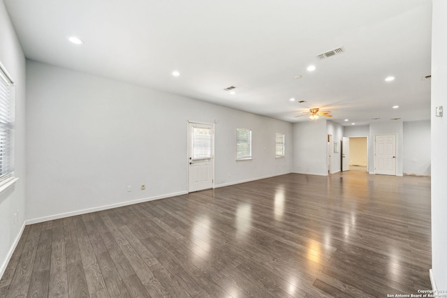 unfurnished living room with ceiling fan and wood-type flooring