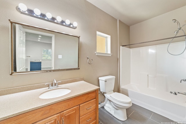 full bathroom featuring shower / bathing tub combination, toilet, a healthy amount of sunlight, tile patterned flooring, and vanity