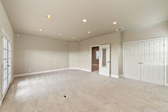 carpeted spare room with french doors