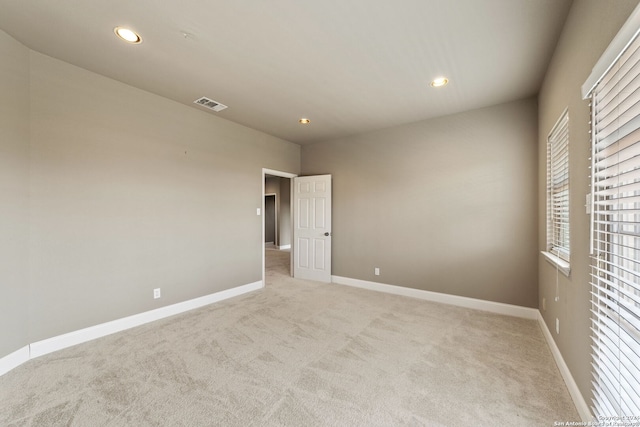 empty room featuring light carpet