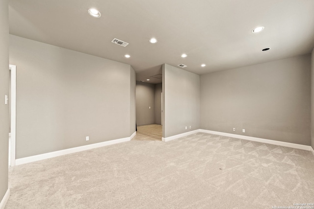 unfurnished room featuring light carpet