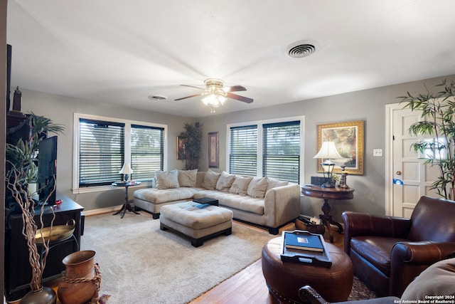 living room featuring ceiling fan and light hardwood / wood-style flooring