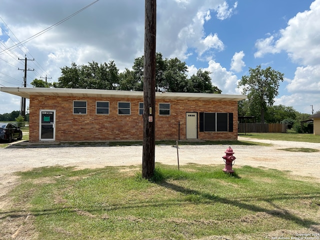 rear view of house with a yard