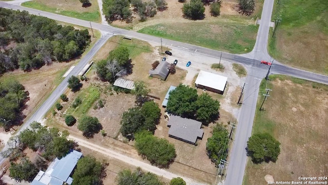 birds eye view of property with a rural view