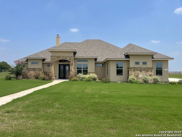 prairie-style home featuring a front yard