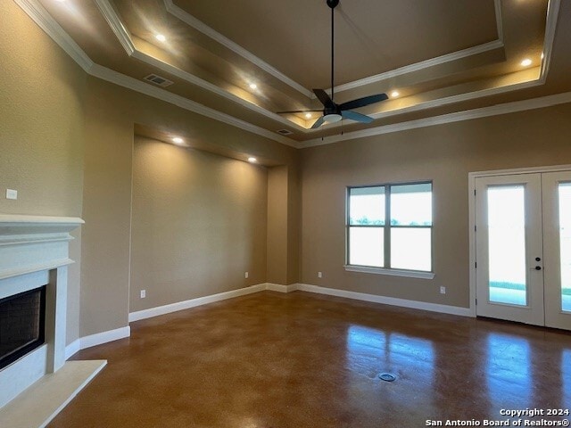 unfurnished living room featuring ceiling fan, a raised ceiling, french doors, and crown molding