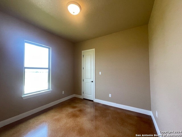 spare room with a textured ceiling