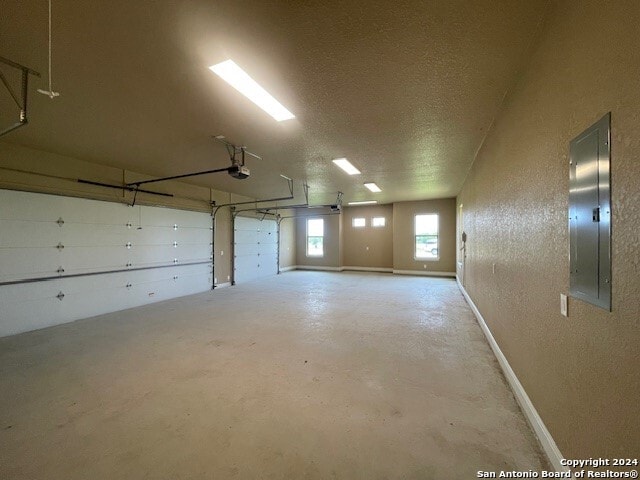 garage featuring a garage door opener and electric panel