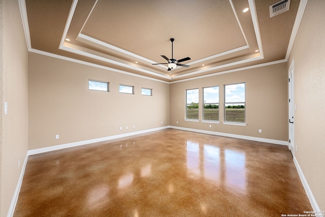 unfurnished room with ceiling fan, a raised ceiling, a textured ceiling, and ornamental molding