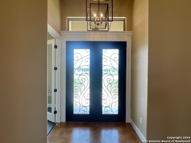 entryway with a chandelier