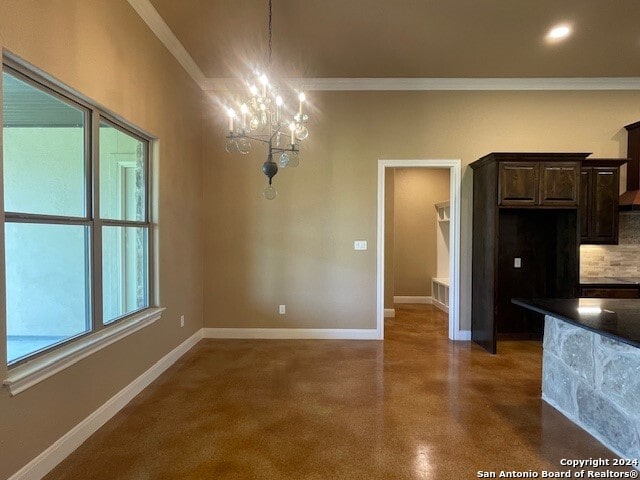 interior space featuring a notable chandelier, crown molding, and concrete flooring