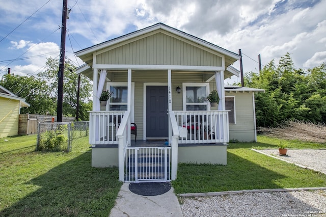 bungalow featuring a porch and a front lawn