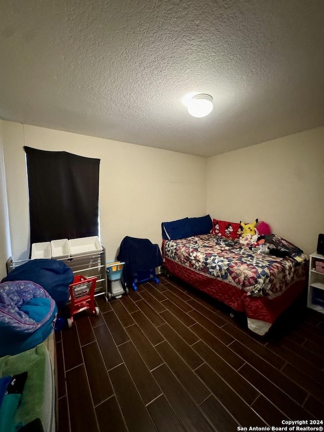 534 Gable Pt, San Antonio, TX 78251 - bedroom with wood finished floors and a textured ceiling