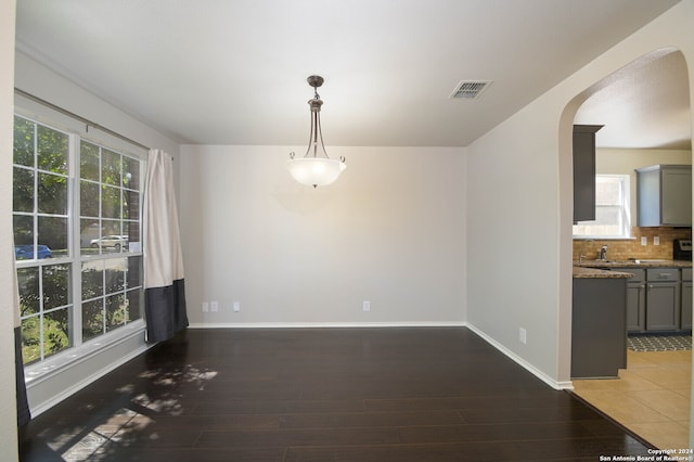 unfurnished dining area featuring tile patterned floors