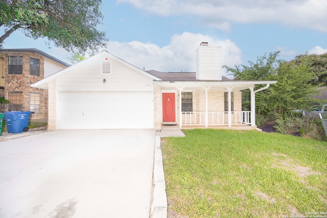 view of front facade with a garage, covered porch, and a front lawn