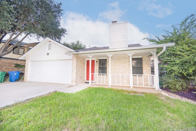 view of front of home with a garage, covered porch, and a front lawn