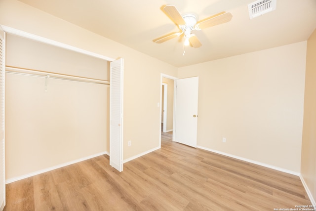 unfurnished bedroom with ceiling fan, light hardwood / wood-style floors, and a closet