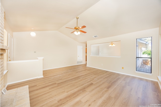 unfurnished living room with ceiling fan, vaulted ceiling, and light wood-type flooring