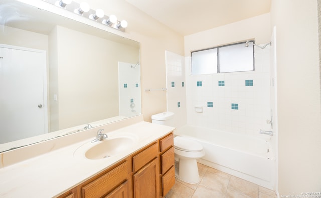 full bathroom featuring vanity, tile patterned flooring, tiled shower / bath combo, and toilet