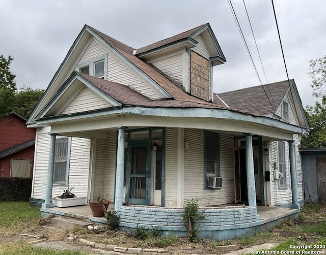 exterior space featuring a porch and cooling unit