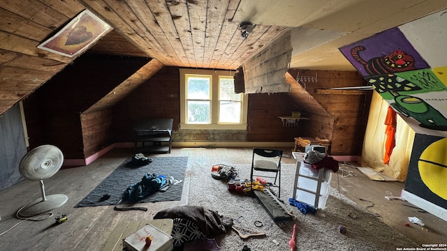 additional living space featuring wooden ceiling, vaulted ceiling, and wood walls