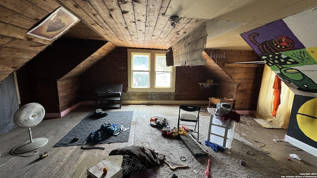 bonus room with wood ceiling, vaulted ceiling, and wood walls