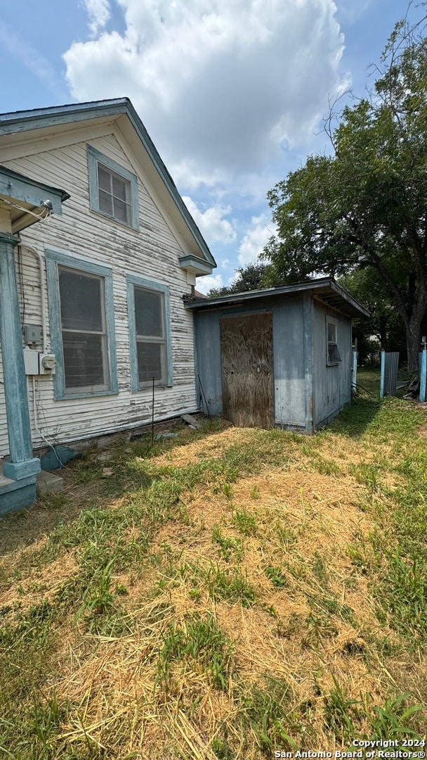 view of property exterior featuring a lawn