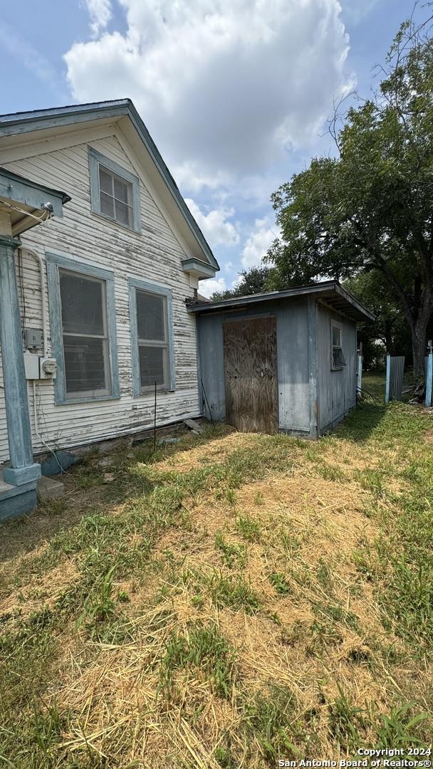 view of side of home featuring a lawn