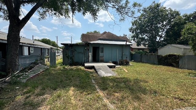 rear view of house with a lawn