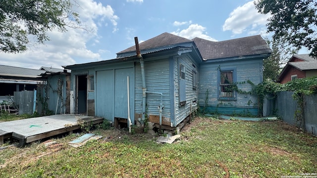 rear view of property with a lawn and a wooden deck