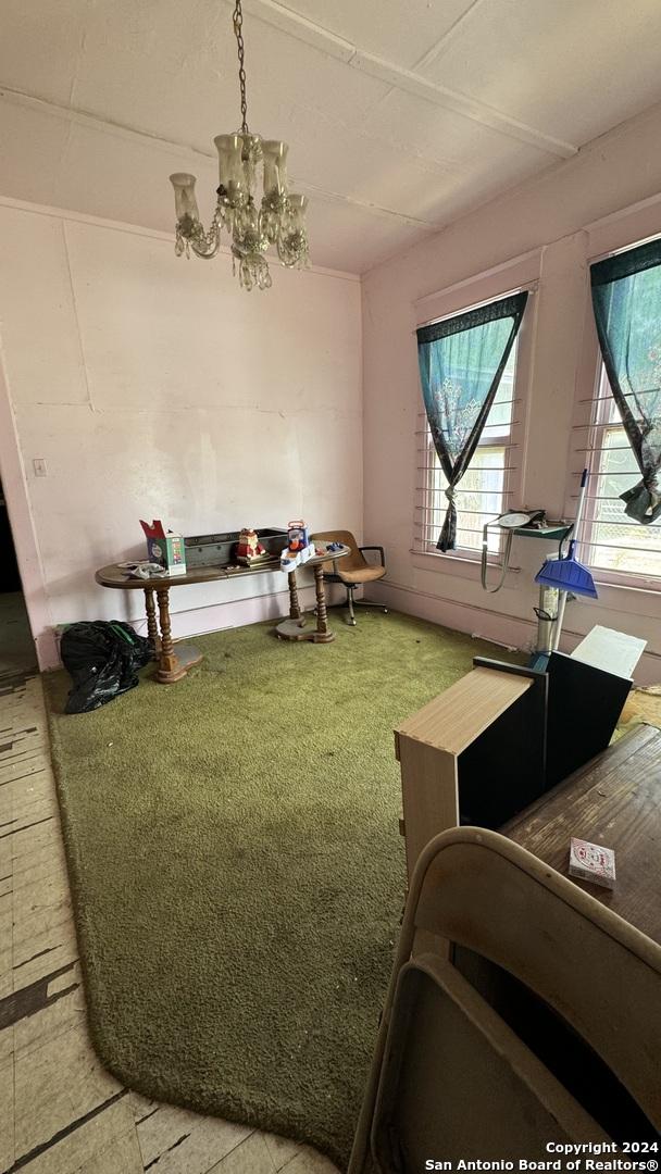 interior space featuring a chandelier and carpet