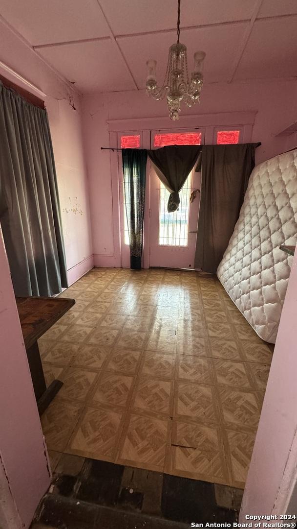 interior space with parquet floors and a chandelier