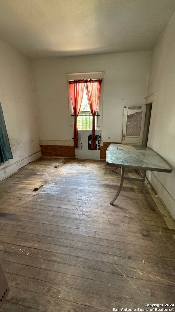 unfurnished room with wood-type flooring