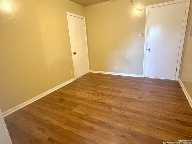 empty room with hardwood / wood-style floors