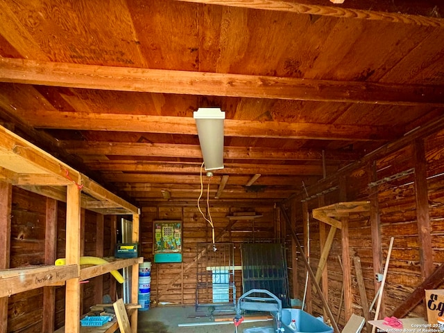 misc room featuring beam ceiling and log walls