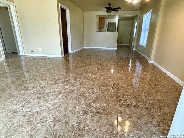 empty room featuring ceiling fan and tile patterned flooring