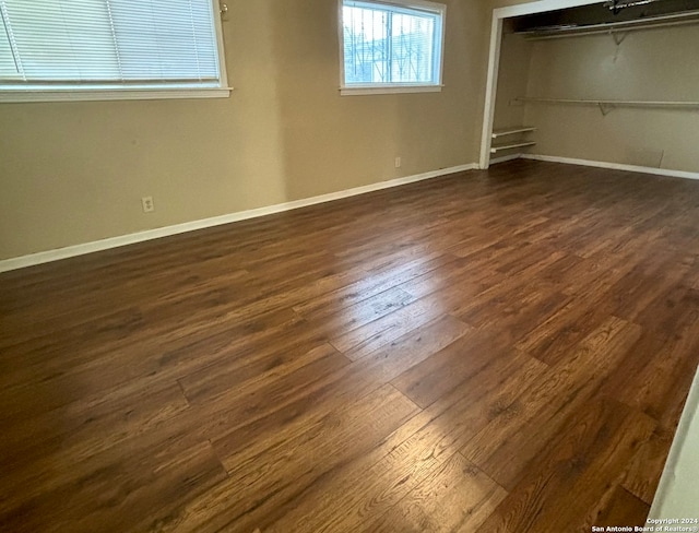 unfurnished bedroom featuring a closet and dark wood-type flooring