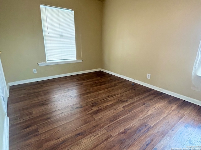 unfurnished room with hardwood / wood-style flooring