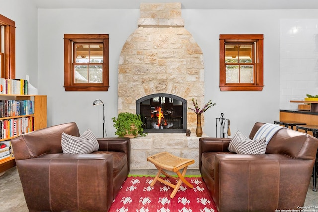 interior space featuring a wealth of natural light and a stone fireplace