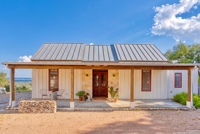 view of front of home featuring metal roof, a standing seam roof, and board and batten siding