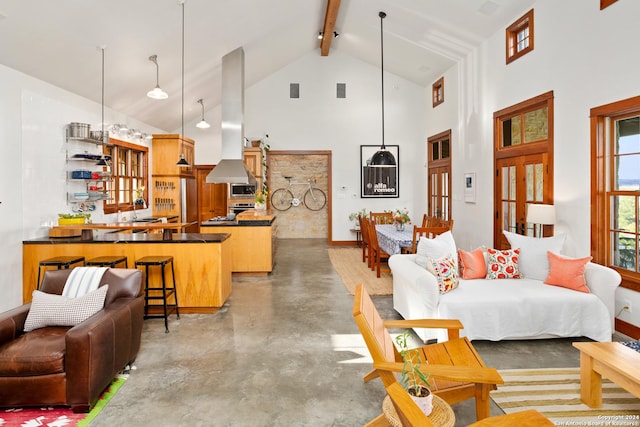 living area with baseboards, concrete floors, high vaulted ceiling, and beam ceiling