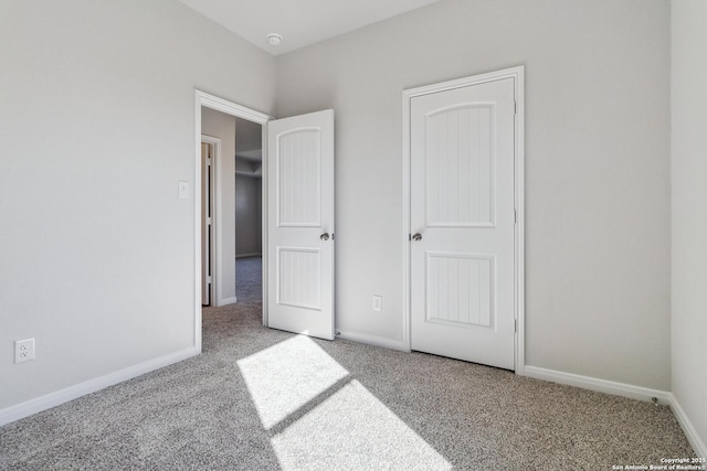 unfurnished bedroom with light colored carpet