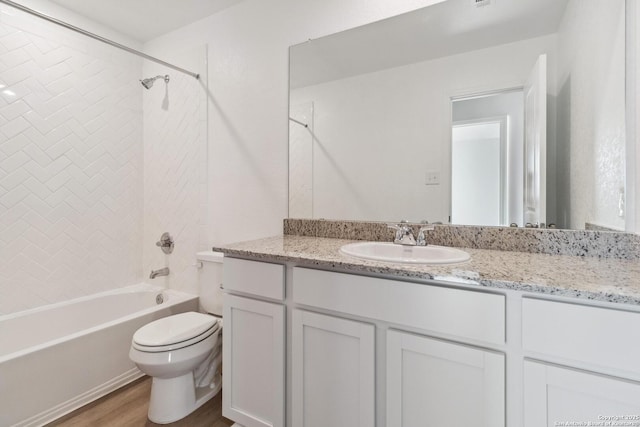 full bathroom with hardwood / wood-style floors, vanity, toilet, and shower / bath combination