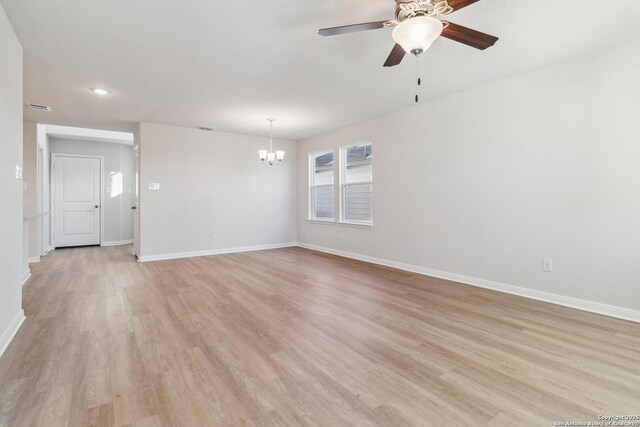 unfurnished living room with light hardwood / wood-style flooring and ceiling fan with notable chandelier