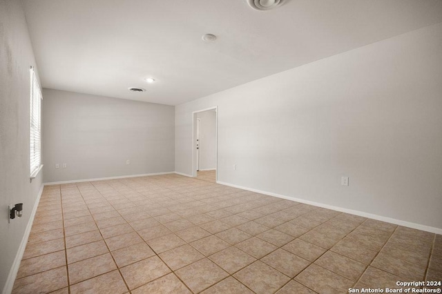 unfurnished room featuring visible vents and baseboards