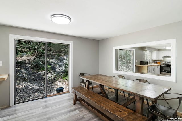 dining space featuring light wood-type flooring