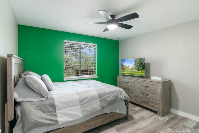 bedroom with ceiling fan and light hardwood / wood-style flooring