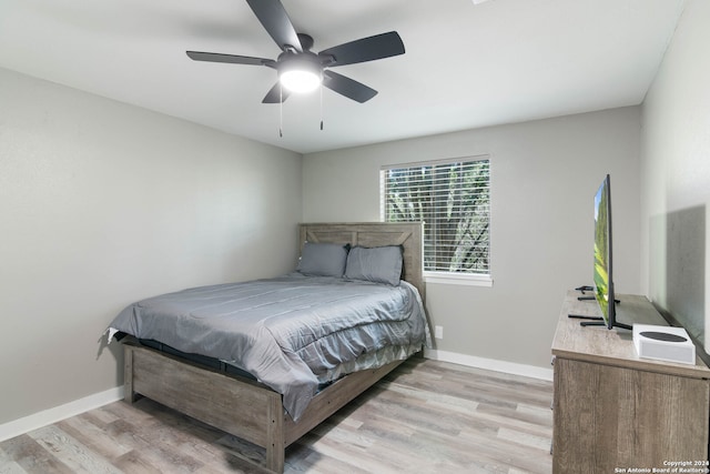 bedroom with light hardwood / wood-style flooring and ceiling fan