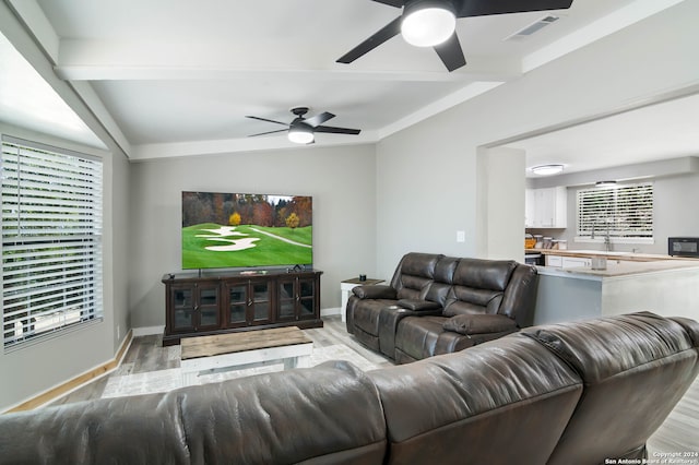 living room featuring light hardwood / wood-style flooring and ceiling fan